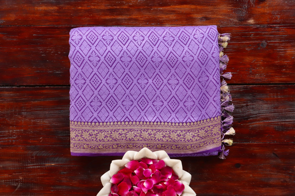 Purple Georgette silk Banarasi saree with densely packed Tanchoi motifs, draped for the camera.