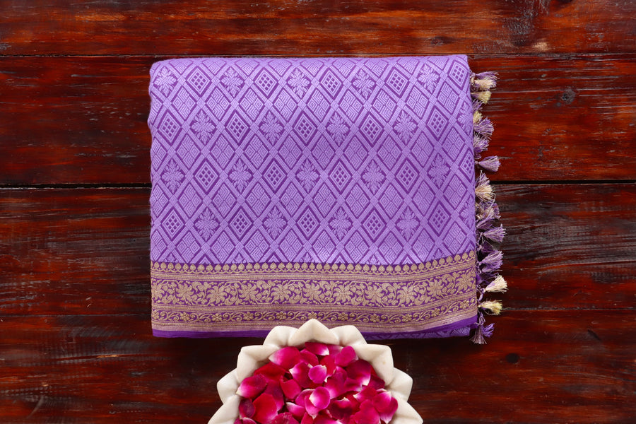 Purple Georgette silk Banarasi saree with densely packed Tanchoi motifs, draped for the camera.