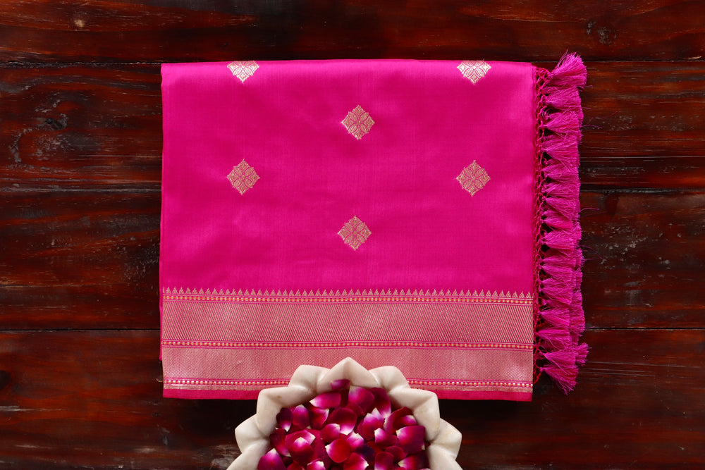 Pink pure silk Banarasi saree with thread-by-thread motifs, draped for the camera.