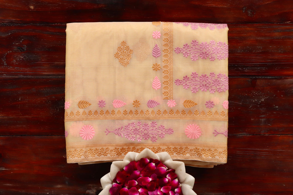 Yellow pure Kora silk Banarasi saree with thread-by-thread motifs, draped for the camera.