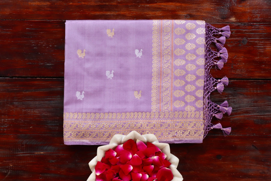 Lilac pure Katan silk Banarasi saree with thread-by-thread motifs, draped for the camera.