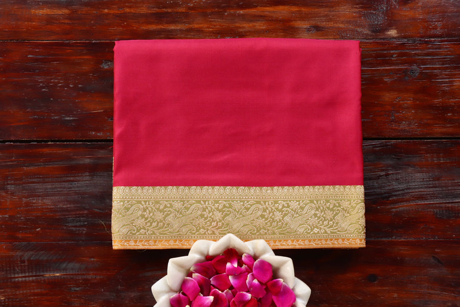 Red Satin silk Banarasi saree with thread-by-thread motifs, draped for the camera.