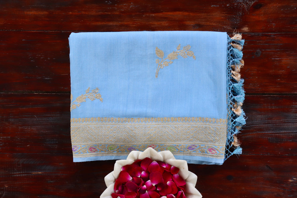Sky Blue Munga silk Banarasi saree with thread-by-thread motifs, draped for the camera.