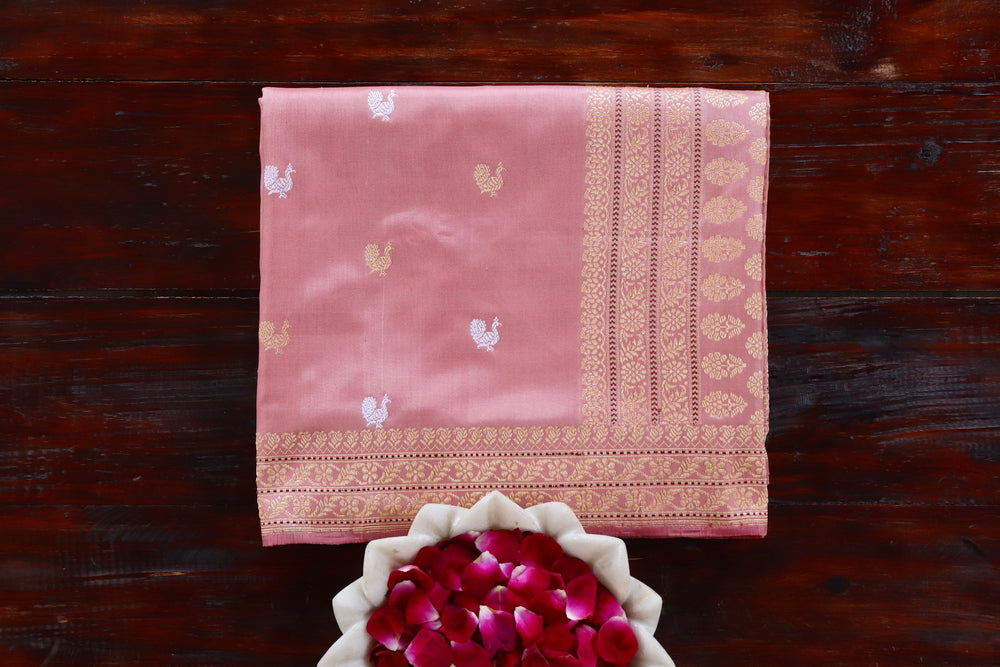 Salmon Pink pure Katan silk Banarasi saree with thread-by-thread motifs, draped for the camera.