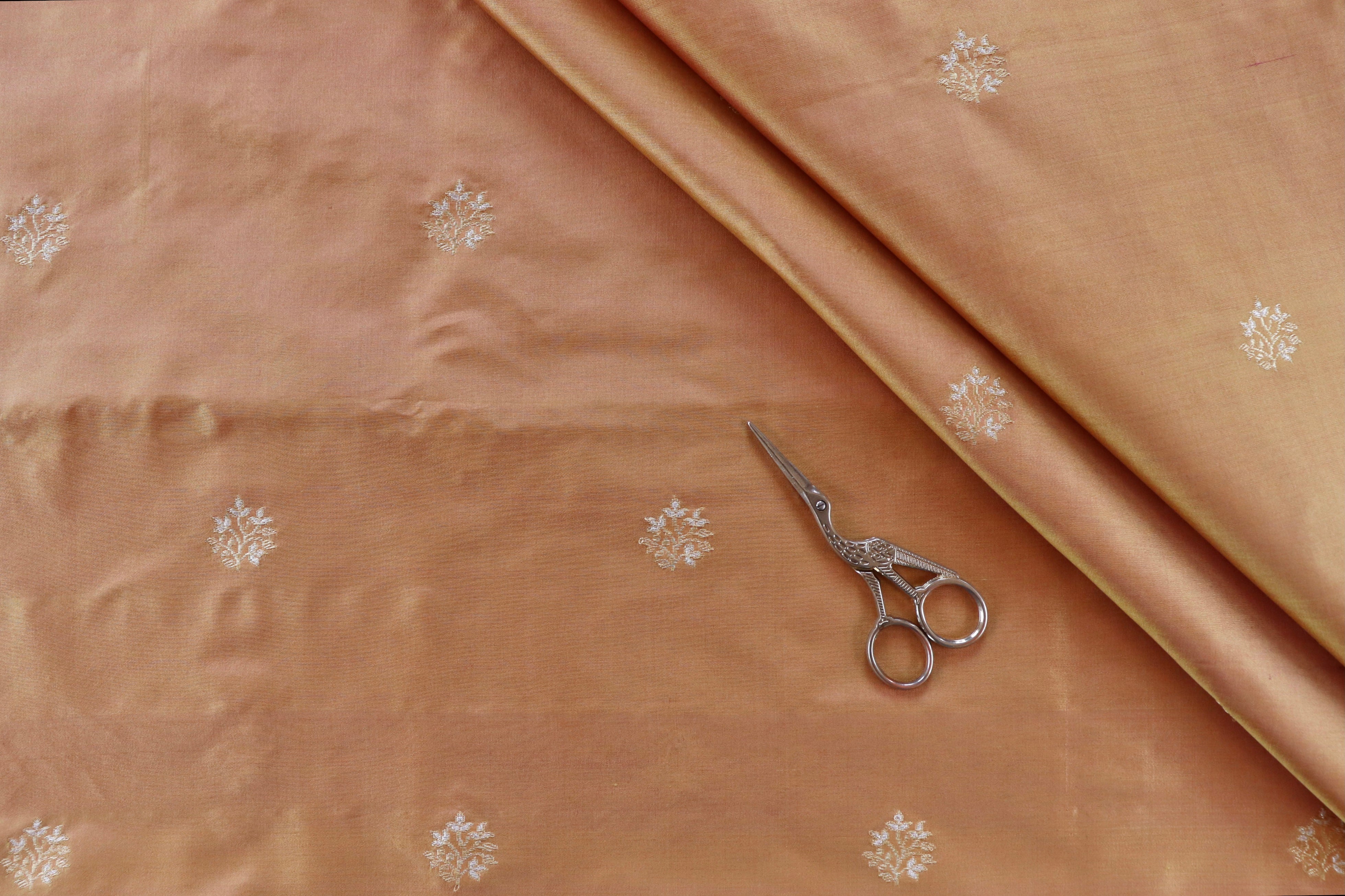 Peach pure Katan silk Banarasi fabric thaan with thread-by-thread motifs.