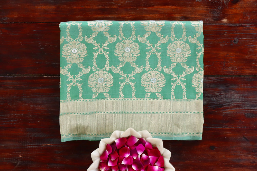 Green handloom Banarsi saree with jangla motifs in pure silk