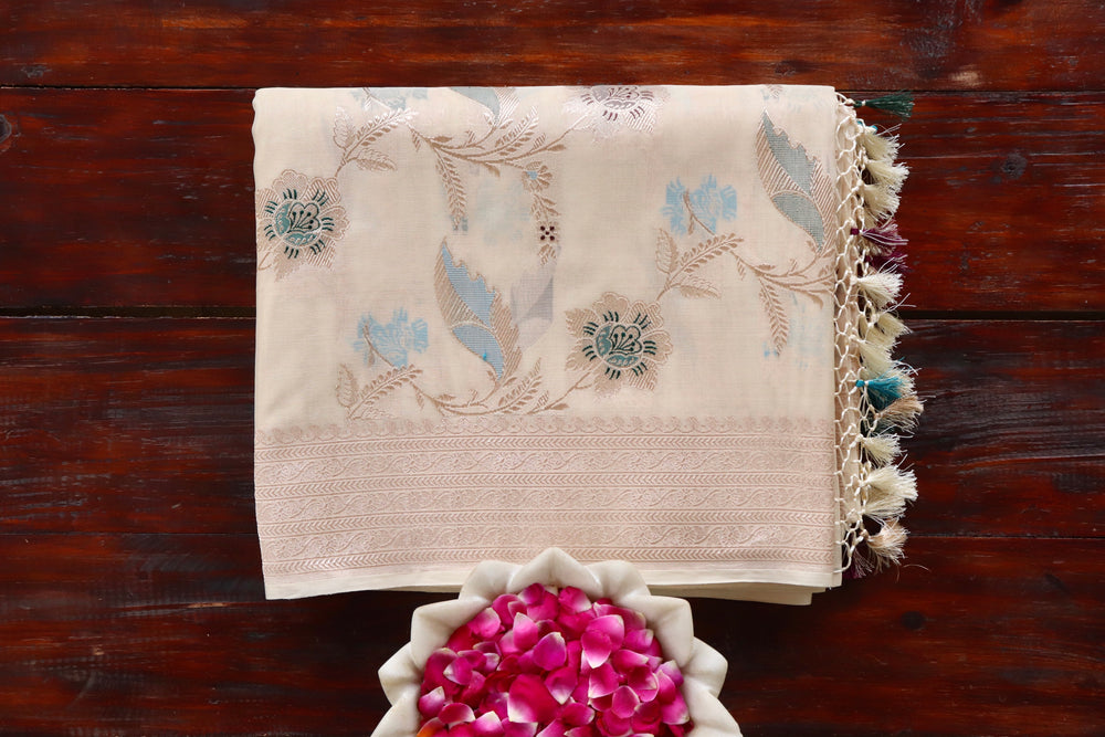 Ivory Organza silk Banarasi saree with scrolling vines and florals in continuous Jangla layout, draped for the camera.