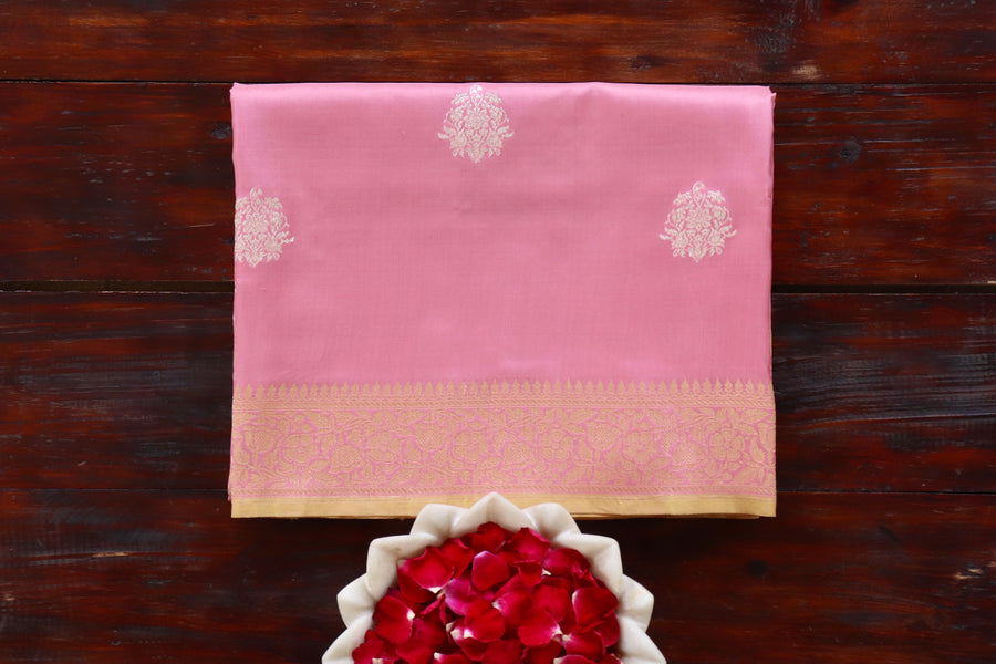 Pink pure Katan silk Banarasi saree with thread-by-thread motifs, draped for the camera.