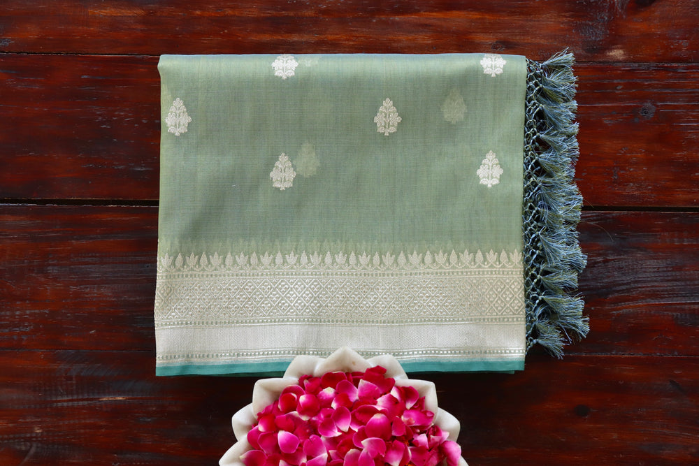 Pista Green Leaf Shear Kora silk Banarasi saree with thread-by-thread motifs, draped for the camera.