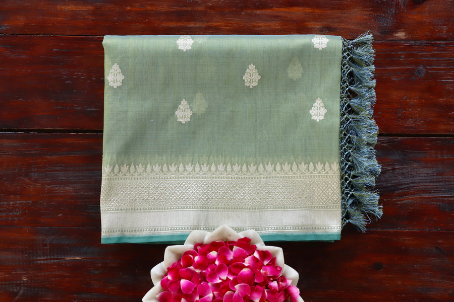 Pista Green Leaf Shear Kora silk Banarasi saree with thread-by-thread motifs, draped for the camera.