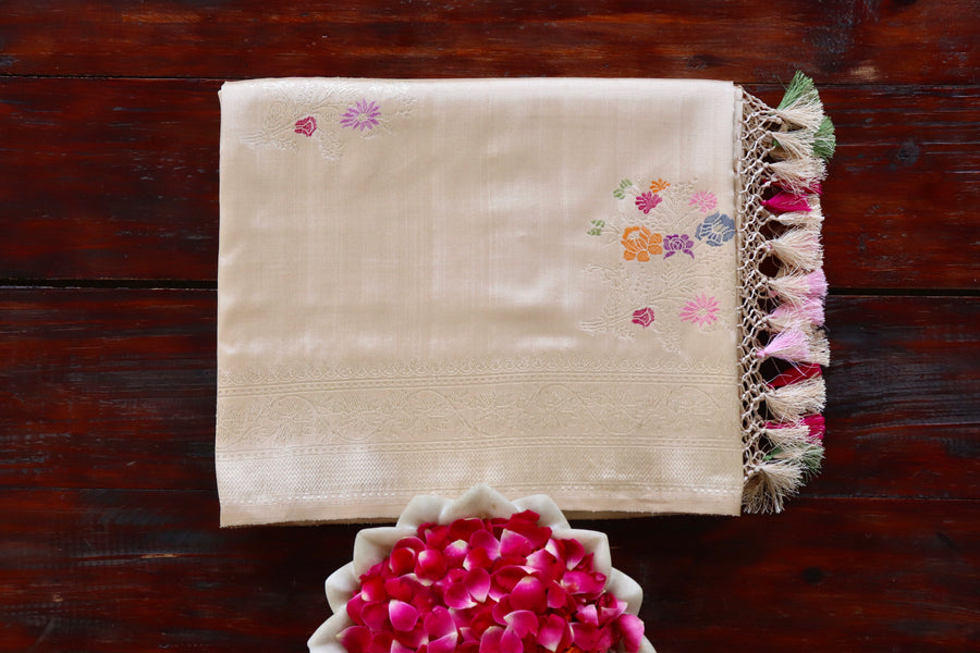 Beige Guldasta pure silk Banarasi saree with thread-by-thread motifs, draped for the camera.