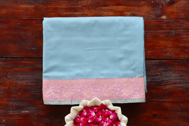 Sky Blue & Pink Satin silk Banarasi saree with thread-by-thread motifs, draped for the camera.