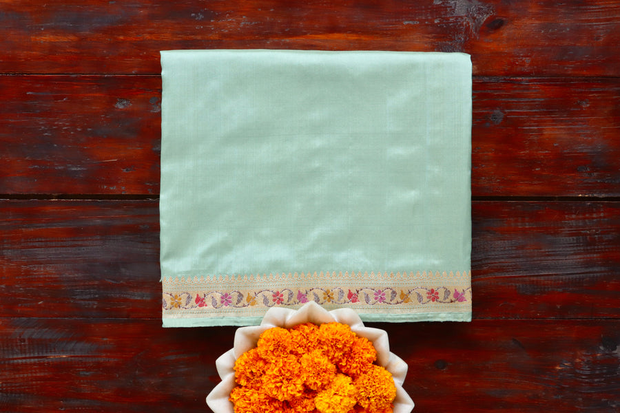 Sea Green Katan silk Banarasi saree with meenakari motifs in coloured silk and zari, draped for the camera.