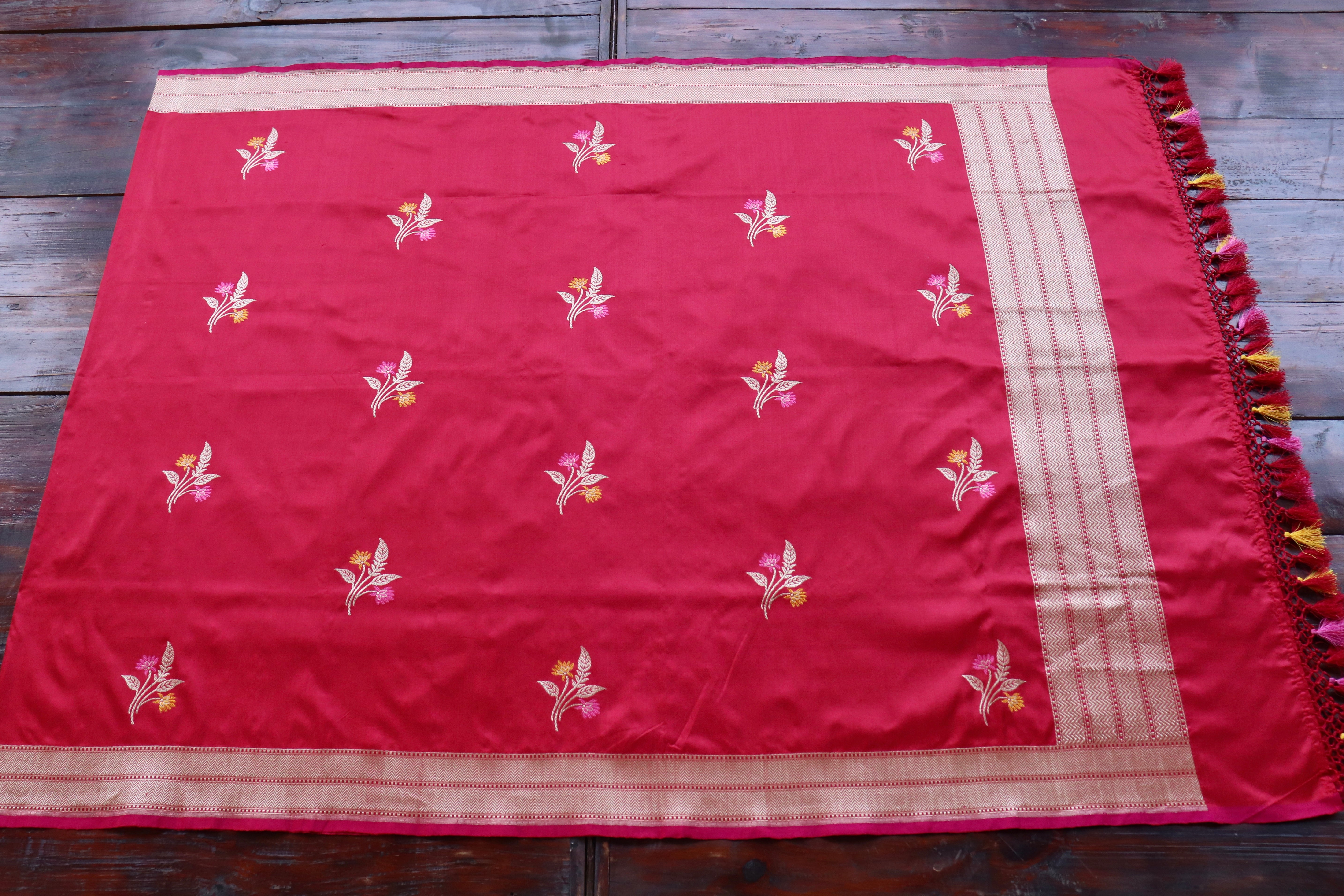 A silk field scattered with meena butis — colour worked into the gold