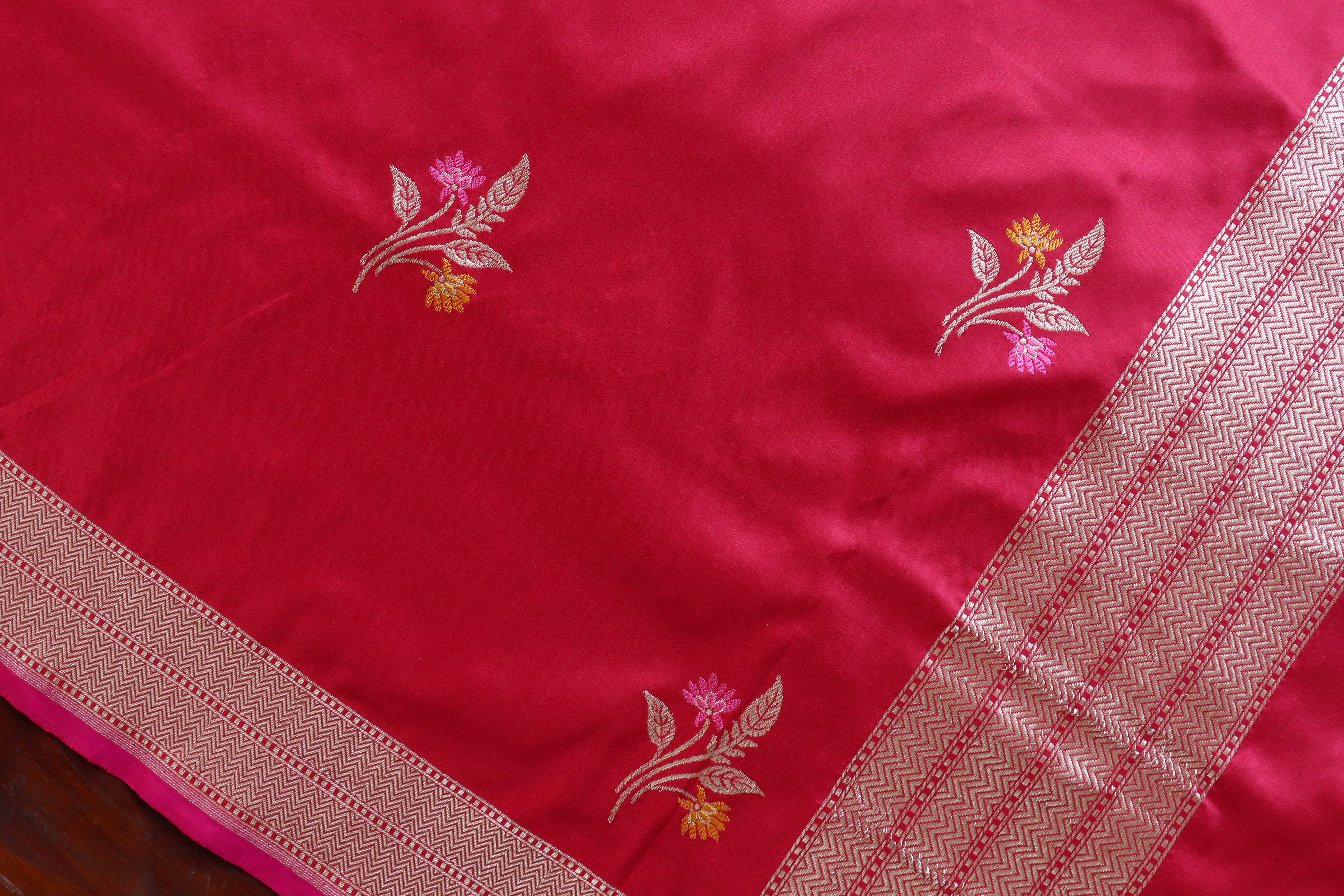 Red silk scattered with meena butis, up close