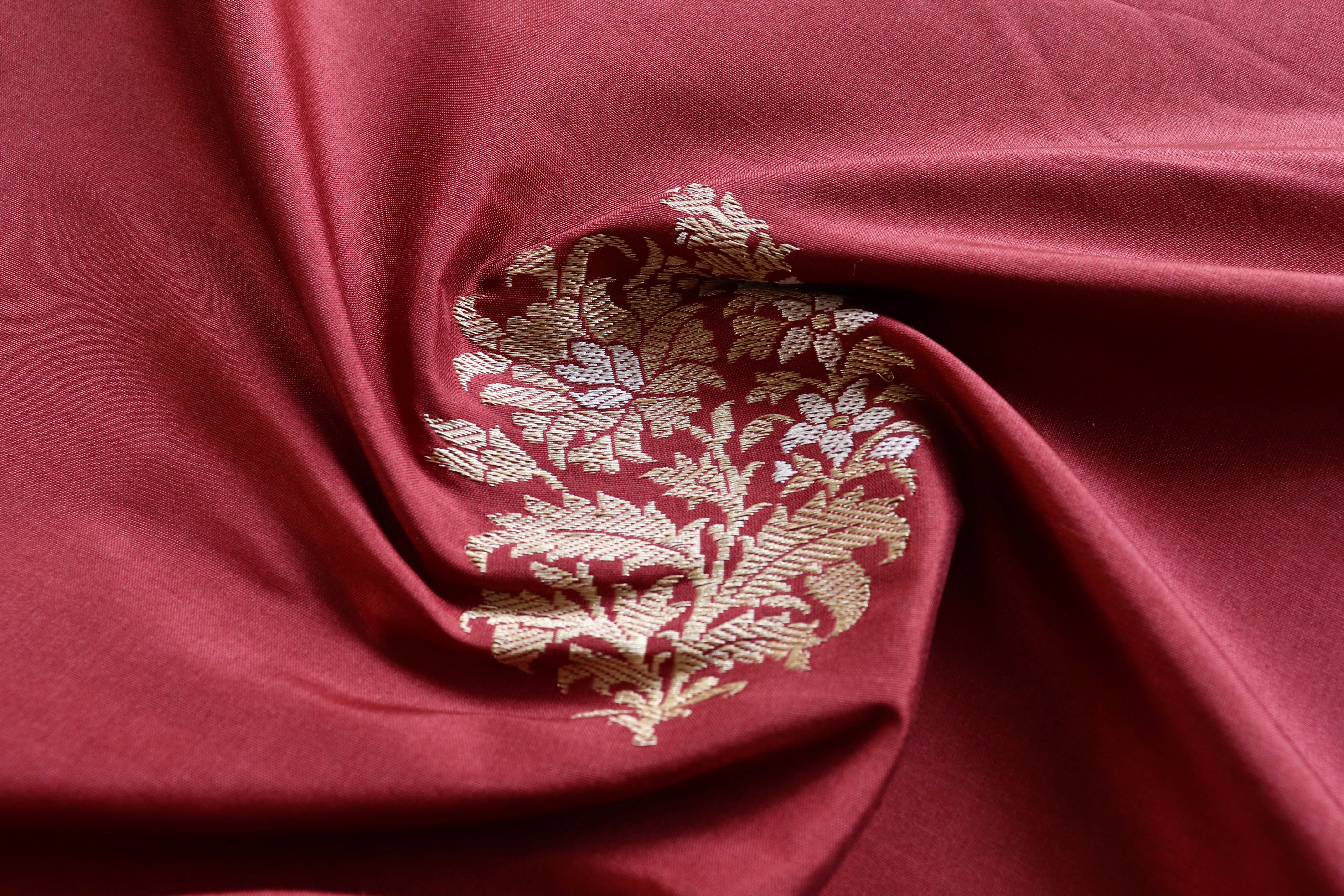 Gold butas on maroon katan silk, gathered in soft folds