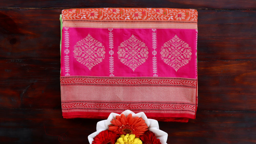 Multicoloured Kora silk Banarasi saree with compartmented Aada layout, draped for the camera.