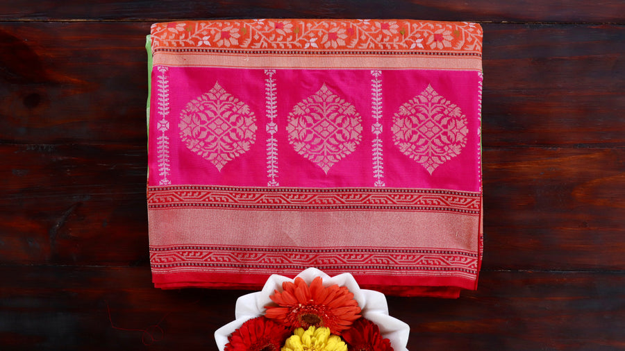 Multicoloured Kora silk Banarasi saree with compartmented Aada layout, draped for the camera.